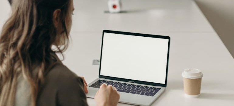 A person using a laptop to find aesthetic clinics in their area