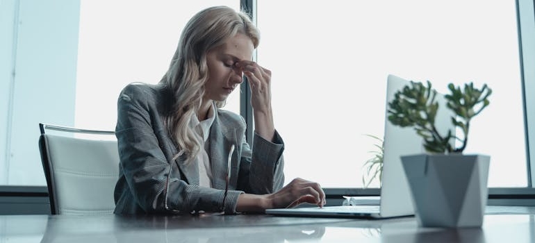 A person struggling with addiction, worrying they will lose their job if they get treatment, which is among the myths about rehab that might be stopping people from seeking help