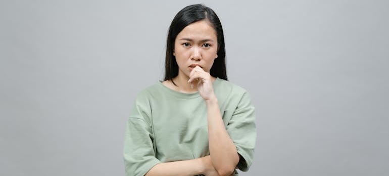 A worried person ashamed to get professional support due to the stigma of addiction, which is among myths about rehab that might be stopping people from seeking help