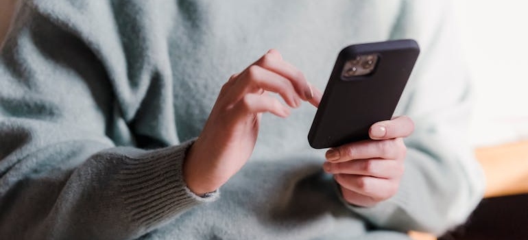A person using a smartphone to look for addiction treatment programs