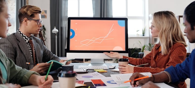 A group of marketing experts discussing teletherapy marketing strategies