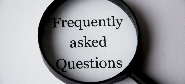 Magnifying glass highlighting frequently asked questions