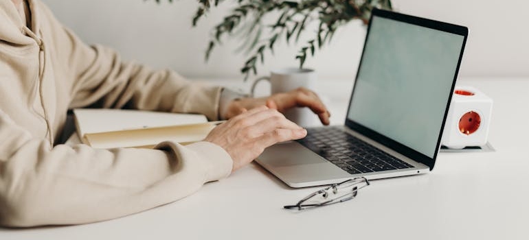 A person doing online research on how mental health clinics can effectively engage schools and employers