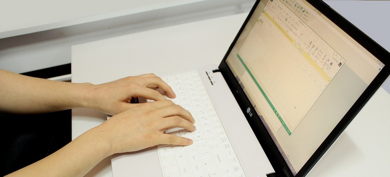 Researching Google’s YMYL Standards for Addiction Treatment Marketing using a laptop.