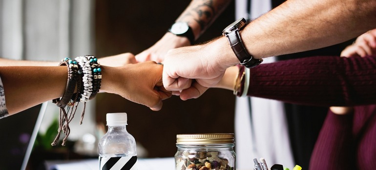 Photo of a diverse group of professionals discussing marketing plans in an office setting.
