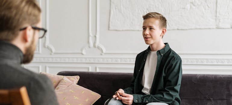 A teenager talking to a therapist during an individual therapy session