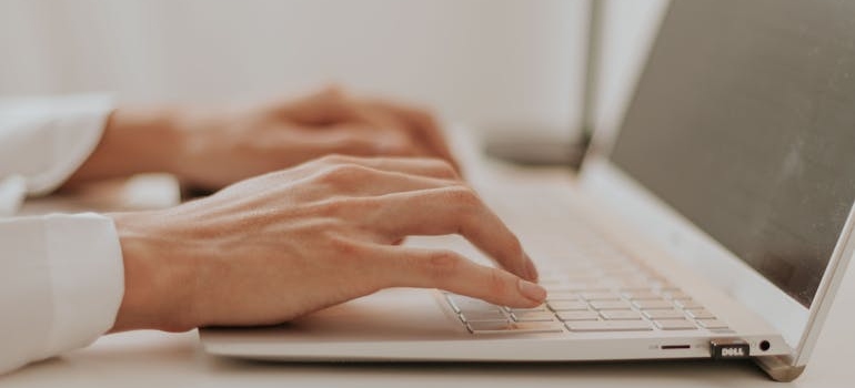 A person using a laptop to edit images