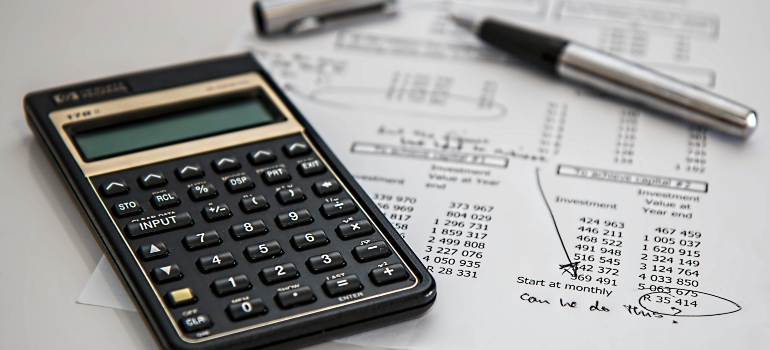 A calculator and a pen on a paper.