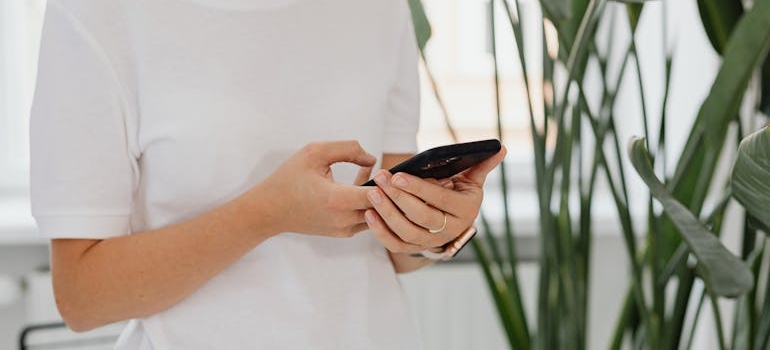 A person using a smartphone to browse a website of a center that knows how web design affects conversion rates