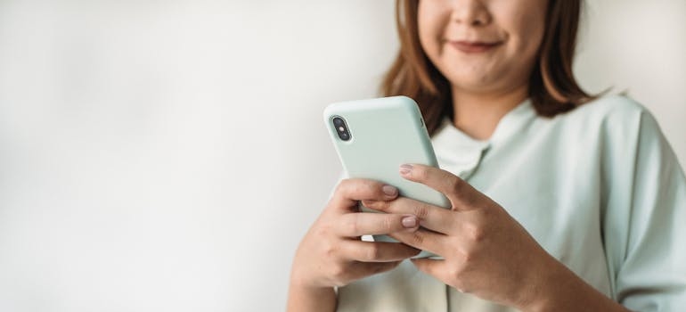 A person using a smartphone to explore services of a company that knows about the impact of 5G on digital marketing