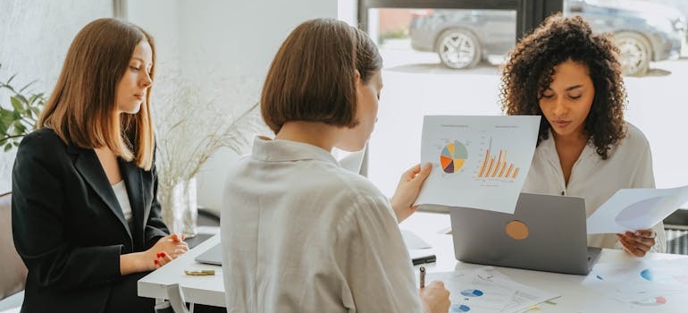 A marketing team using charts and data to evaluate their email campaign ideas to engage alumni and families