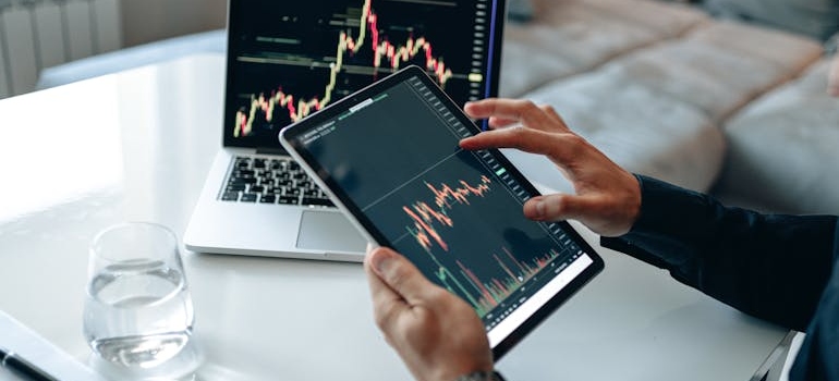 A person analyzing a price chart to improve their personal finances, which is one of industries that get the most leads from affiliate marketing