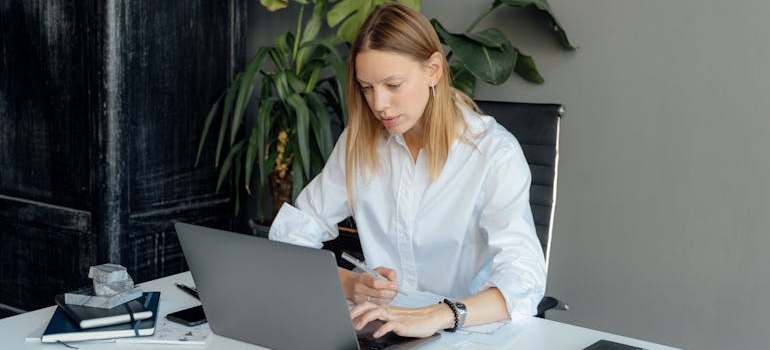 A business person using a laptop and doing research on why you must check if your website was hit by a Google penalty