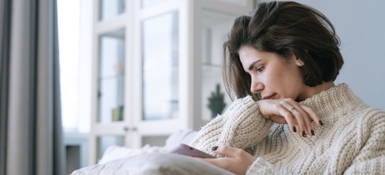 A person using a smartphone and reading content of websites for people in emotional distress