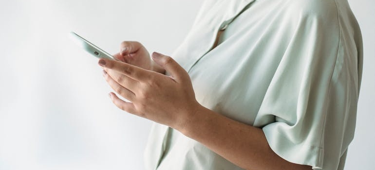 A person using a smartphone to check sites for business reviews in the US