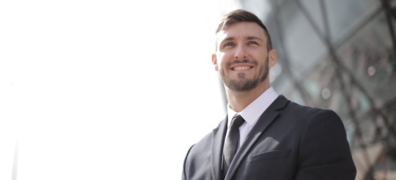 Business professional in a suit standing outside an office building