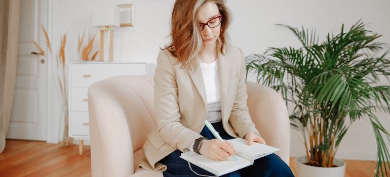 A therapist taking notes while talking to a patient